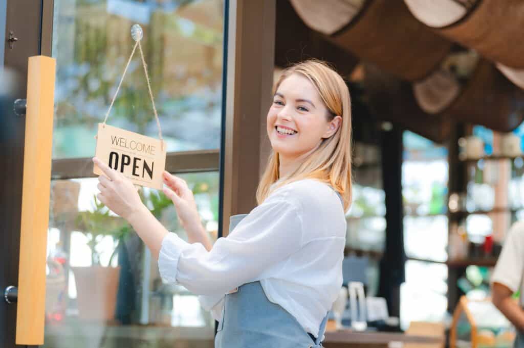 business cafes owner woman or barista worker wearing apron opening a coffee shop to start a business